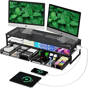 Black metal desktop organizer with dual monitor stand, wireless charging pad, and multiple storage compartments holding books, office supplies, and tech accessories. Two devices are connected and charging below