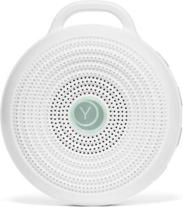 Yogasleep Hushh portable white noise machine in white – circular design with perforated speaker grille and loop handle, a portable sound machine for sleeping, travel, or soothing baby sleep.