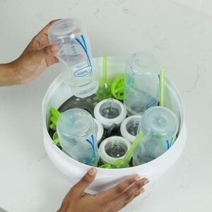 Dr. Brown’s baby bottle sterilizer filled with bottles and accessories, offering time-saving baby tech that ensures fast, hygienic cleaning for busy parents.